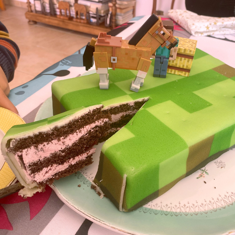 Minecraft® figure on game world cake