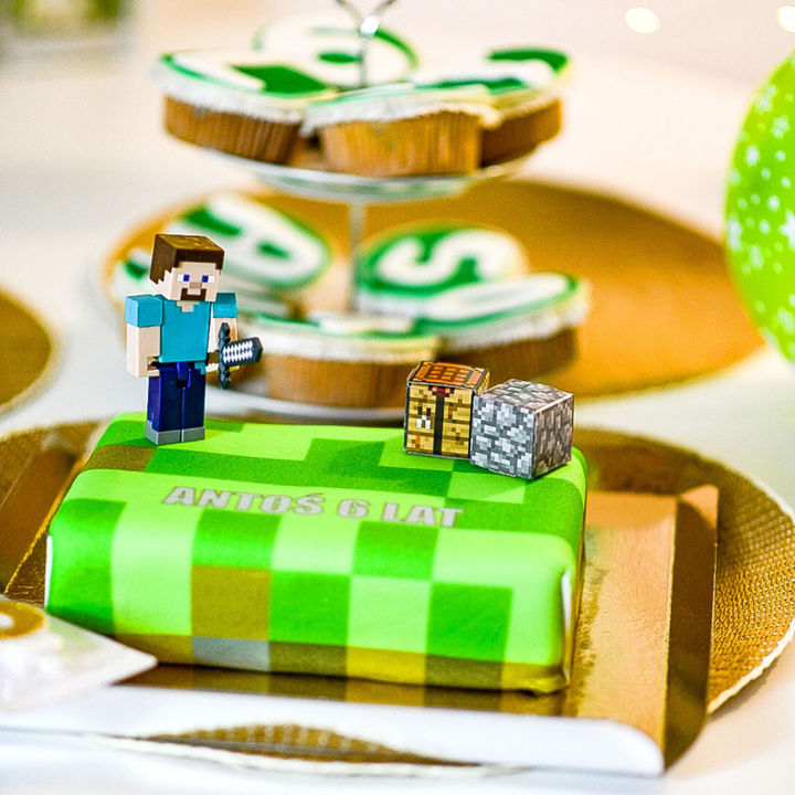 Minecraft® figure on game world cake