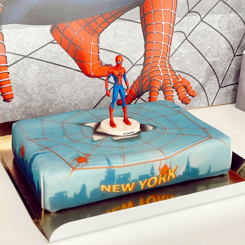 Spider-Man® on a spider’s web over New York cake