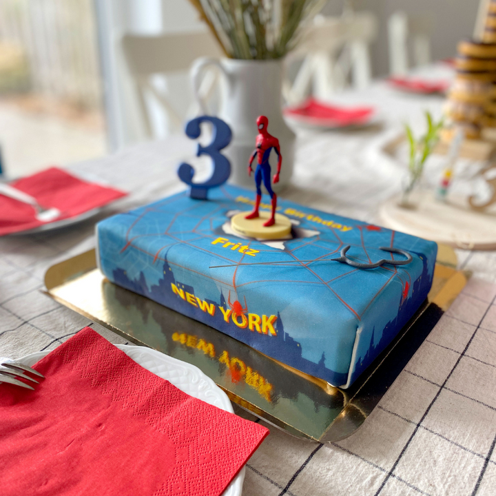 Spider-Man® on a spider’s web over New York cake