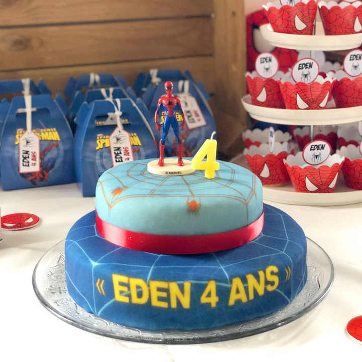 Spider-Man® on a two-tier spider’s web cake with ribbon