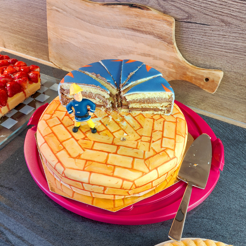 Fireman Sam® on a two-tier fire-themed cake