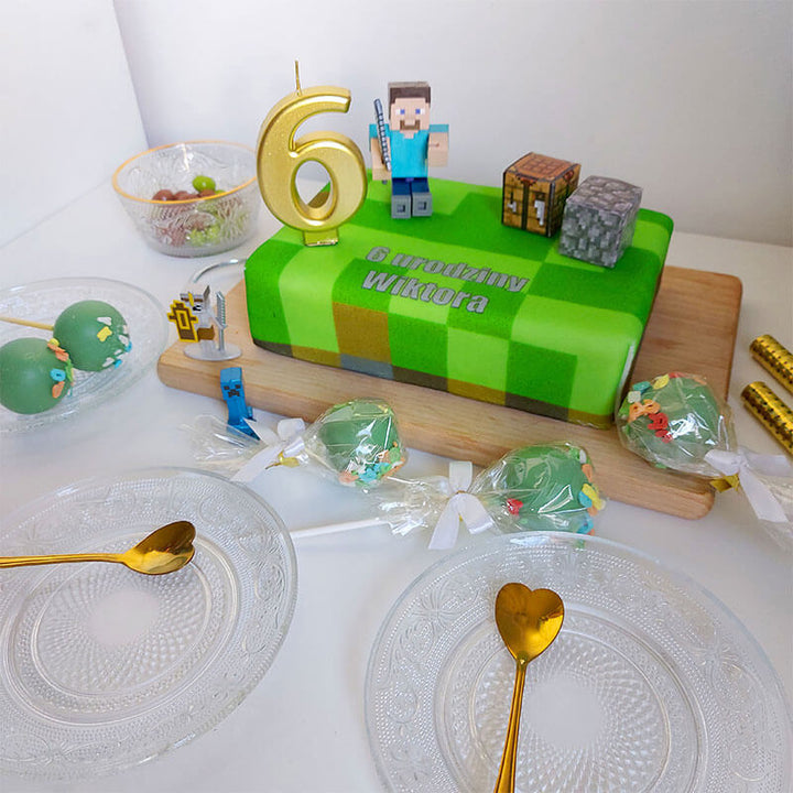 Minecraft® figure on game world cake