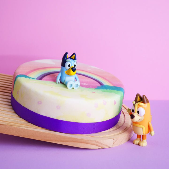 Bluey® figure on rainbow cake