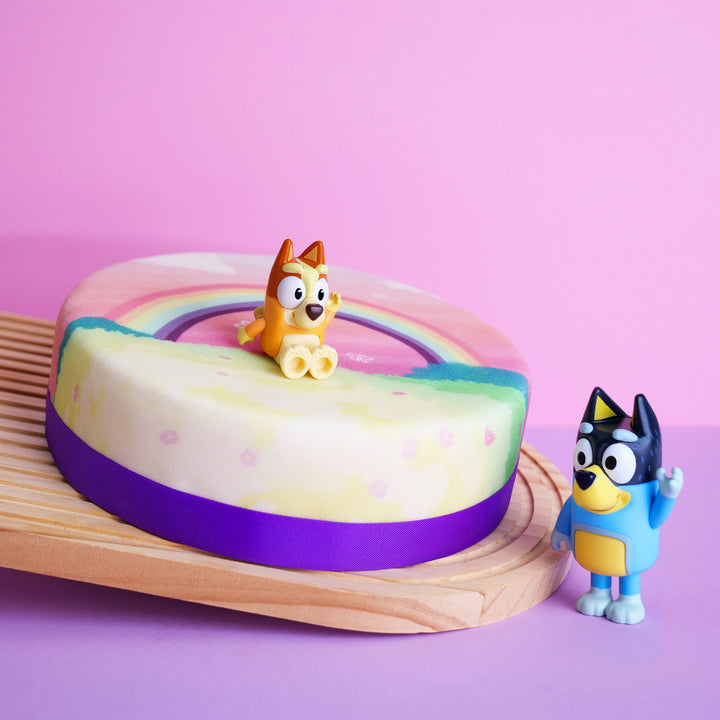 Bluey® figure on rainbow cake