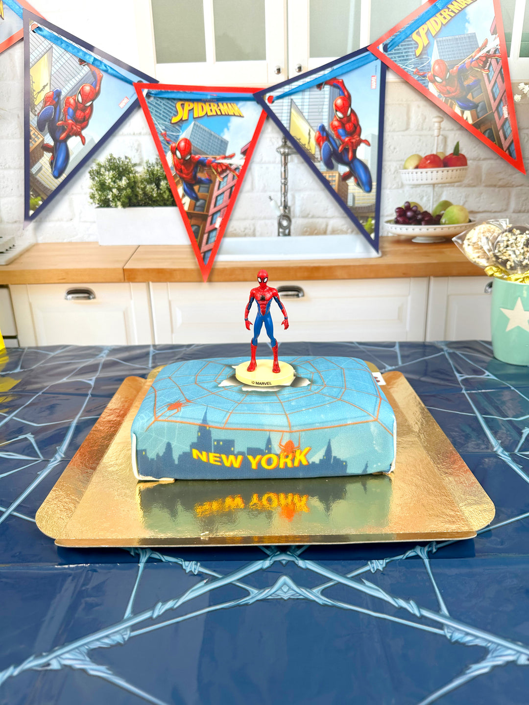 Spider-Man® on a spider’s web over New York cake