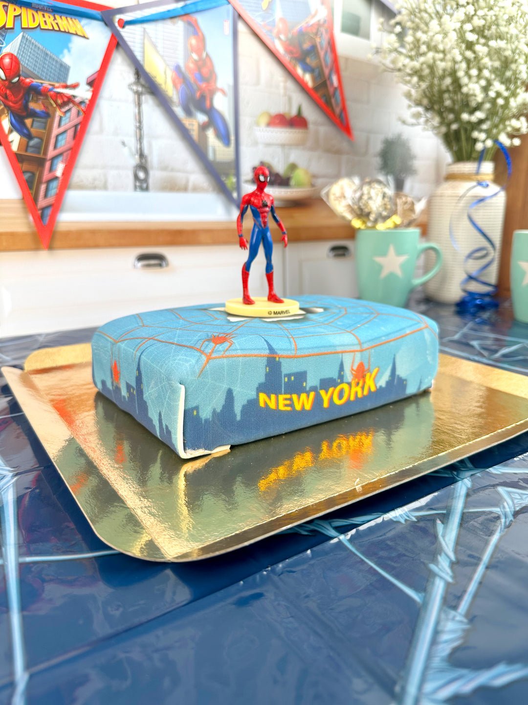 Spider-Man® on a spider’s web over New York cake