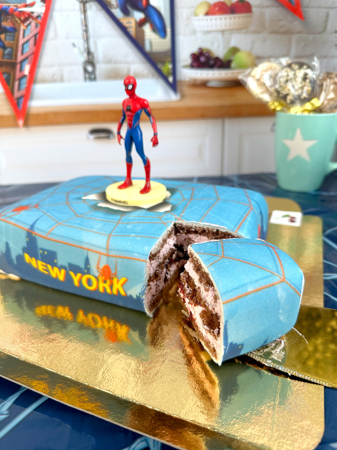 Spider-Man® on a spider’s web over New York cake