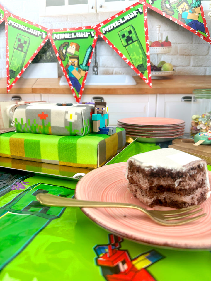 Minecraft® figure on a two-tier game world cake