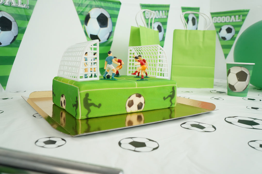 Football pitch cake with footballers