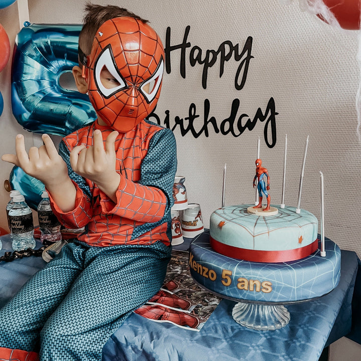 Spider-Man® on a two-tier spider’s web cake with ribbon