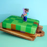 Minecraft® figure on game world cake