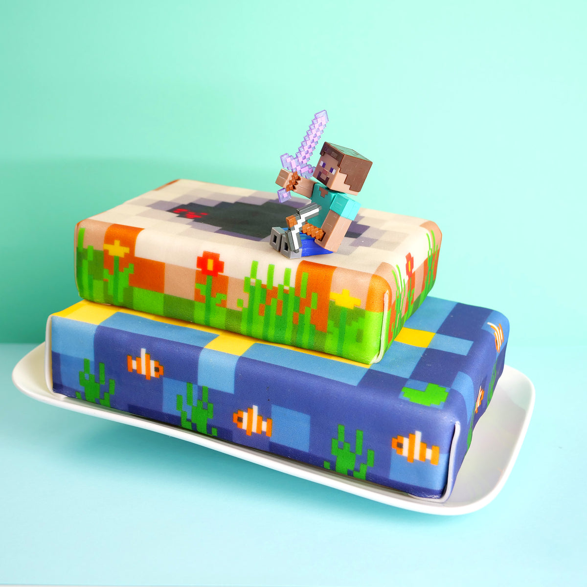 Minecraft® figure on a two-tiered coastal cake