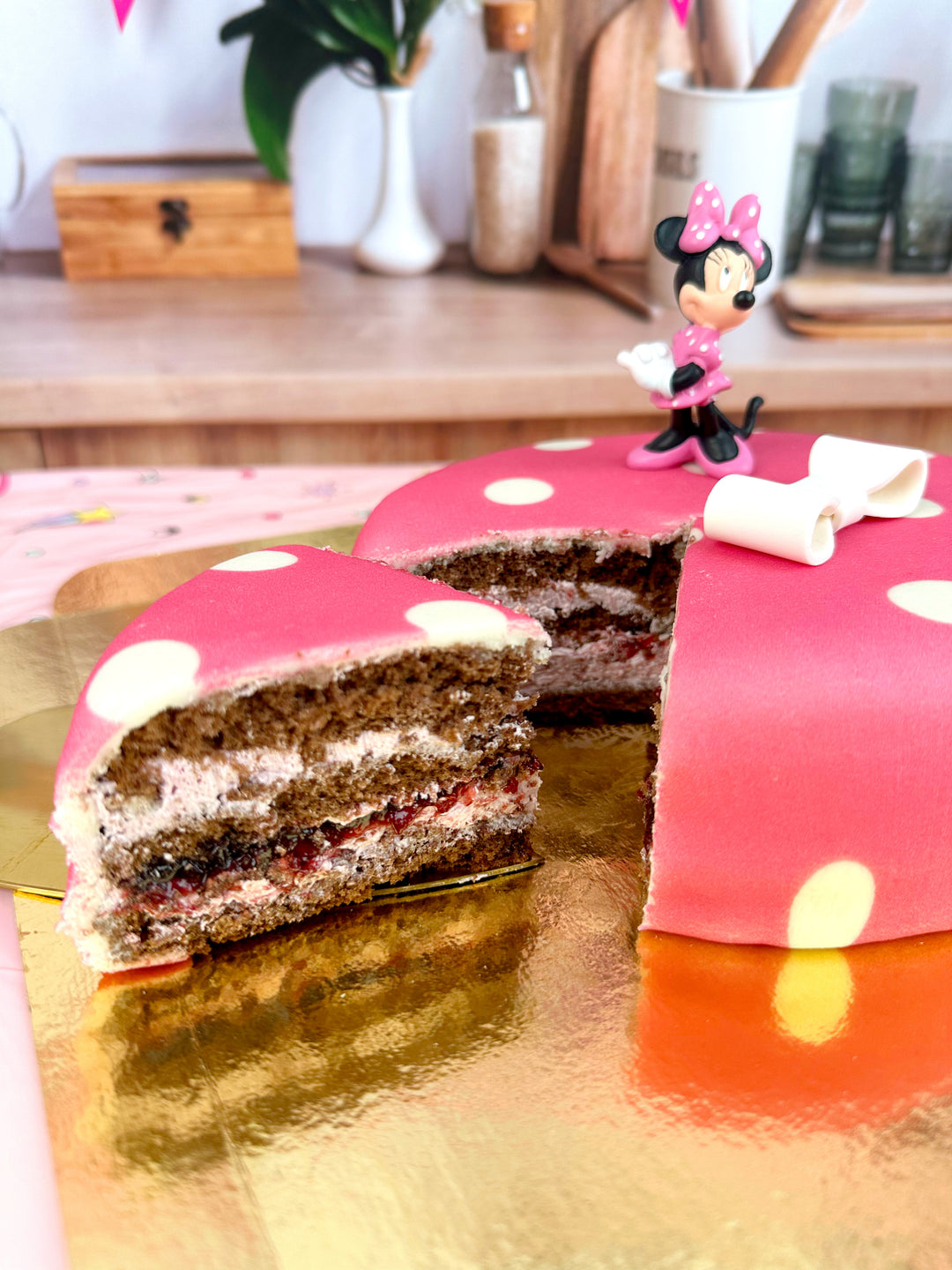 Minnie® Mouse on polka dot cake with ribbon