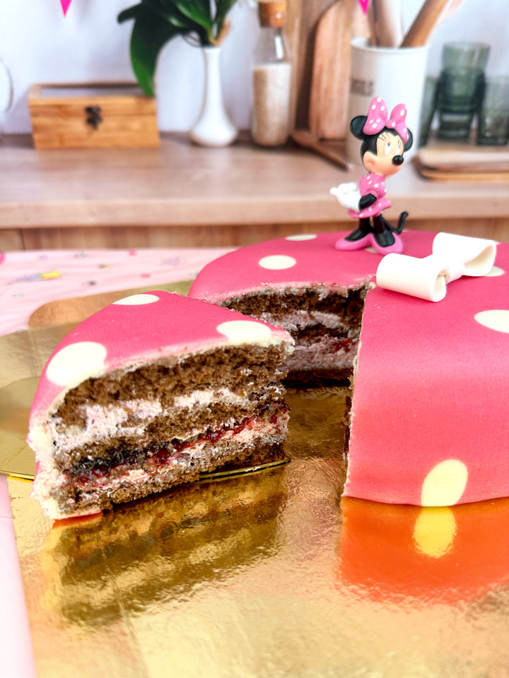 Minnie® Mouse on polka dot cake with ribbon