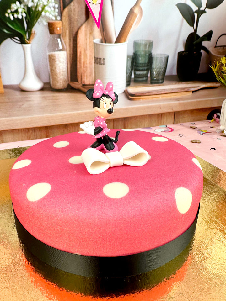 Minnie® Mouse on polka dot cake with ribbon