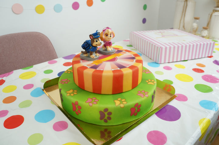 Paw Patrol® on a 2-tier pink dog paw cake