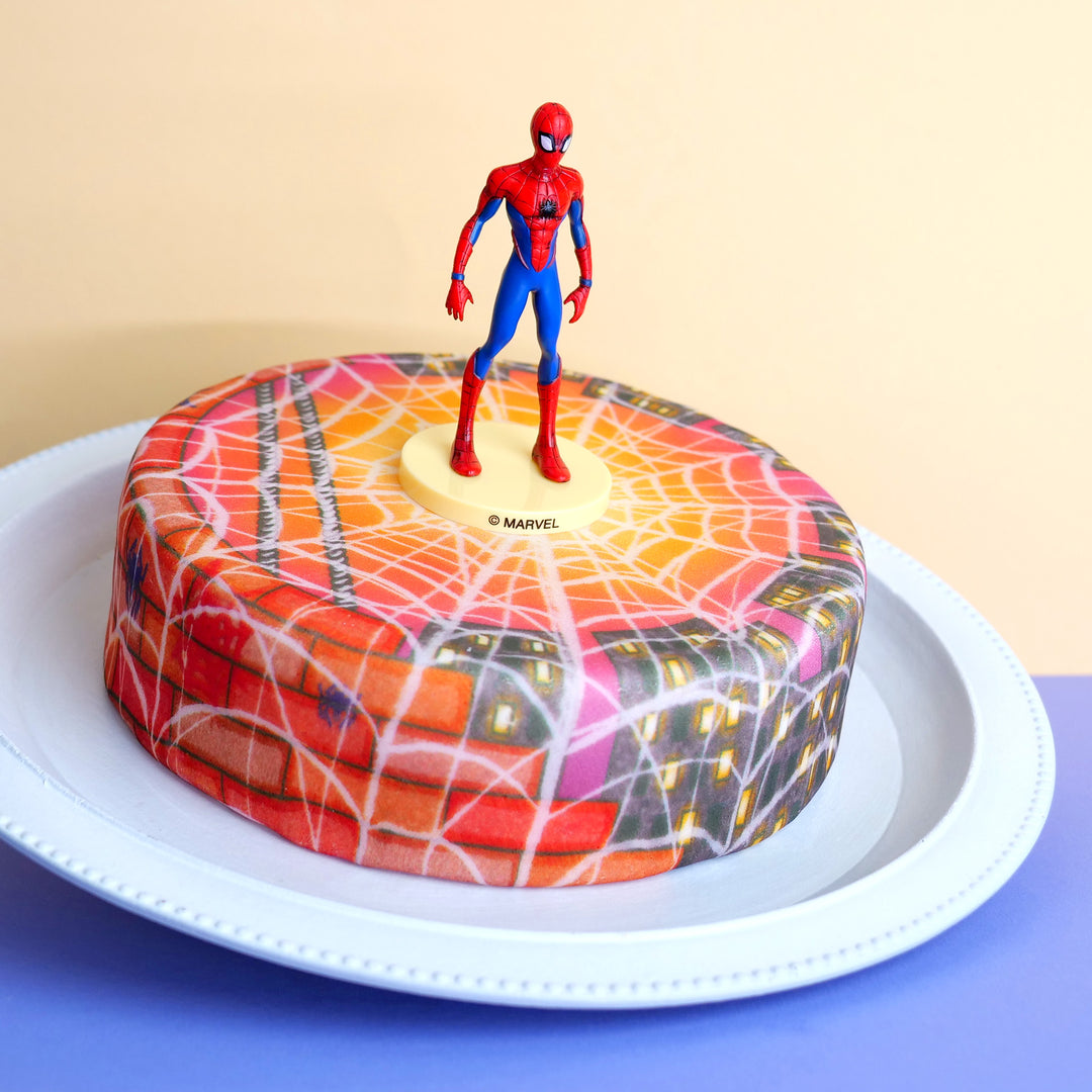 Spider-Man® on a web-adorned city-themed evening cake