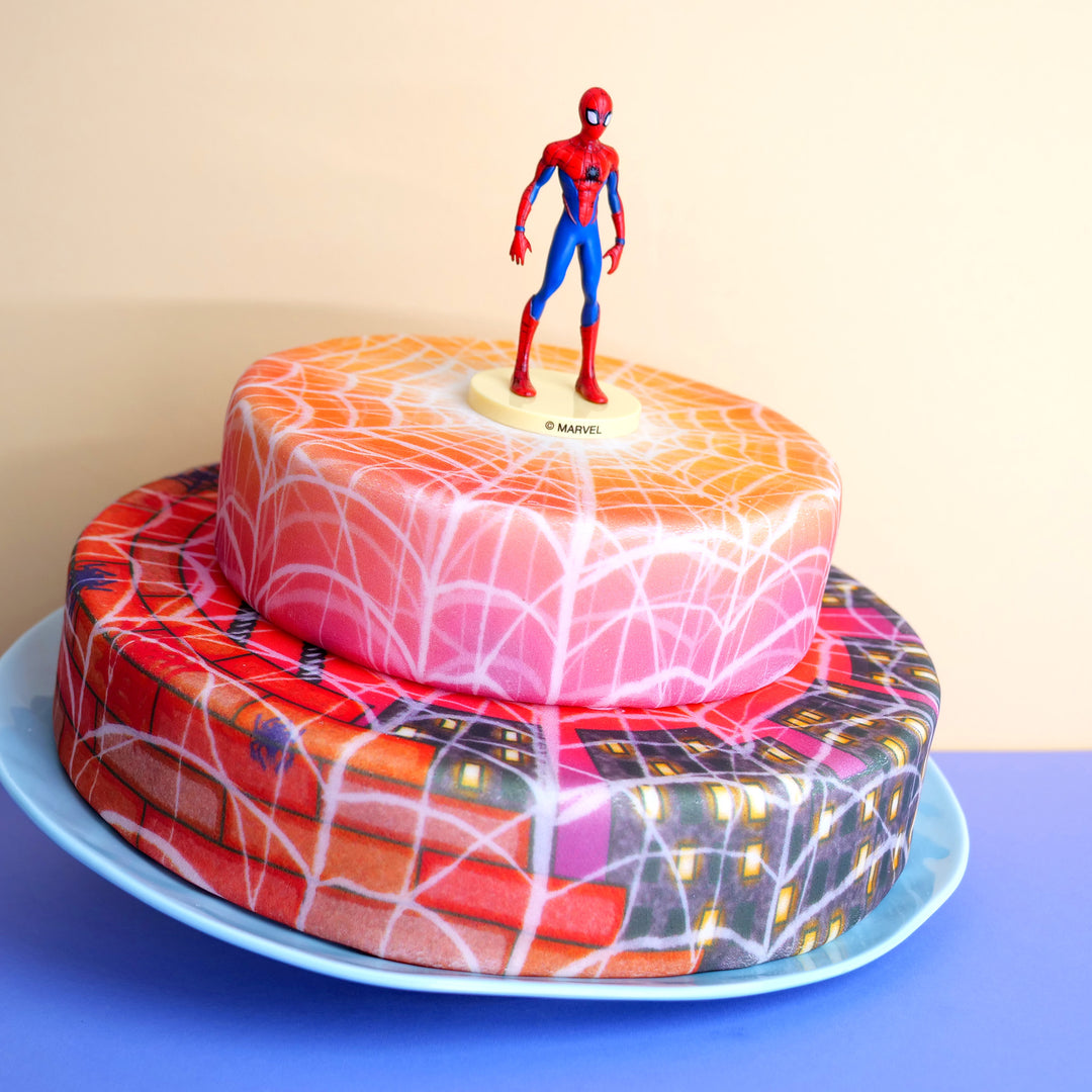 Spider-Man® on a 2-tier webbed city-themed evening cake