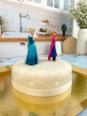 Anna and Elsa from Frozen® on a snowflake cake