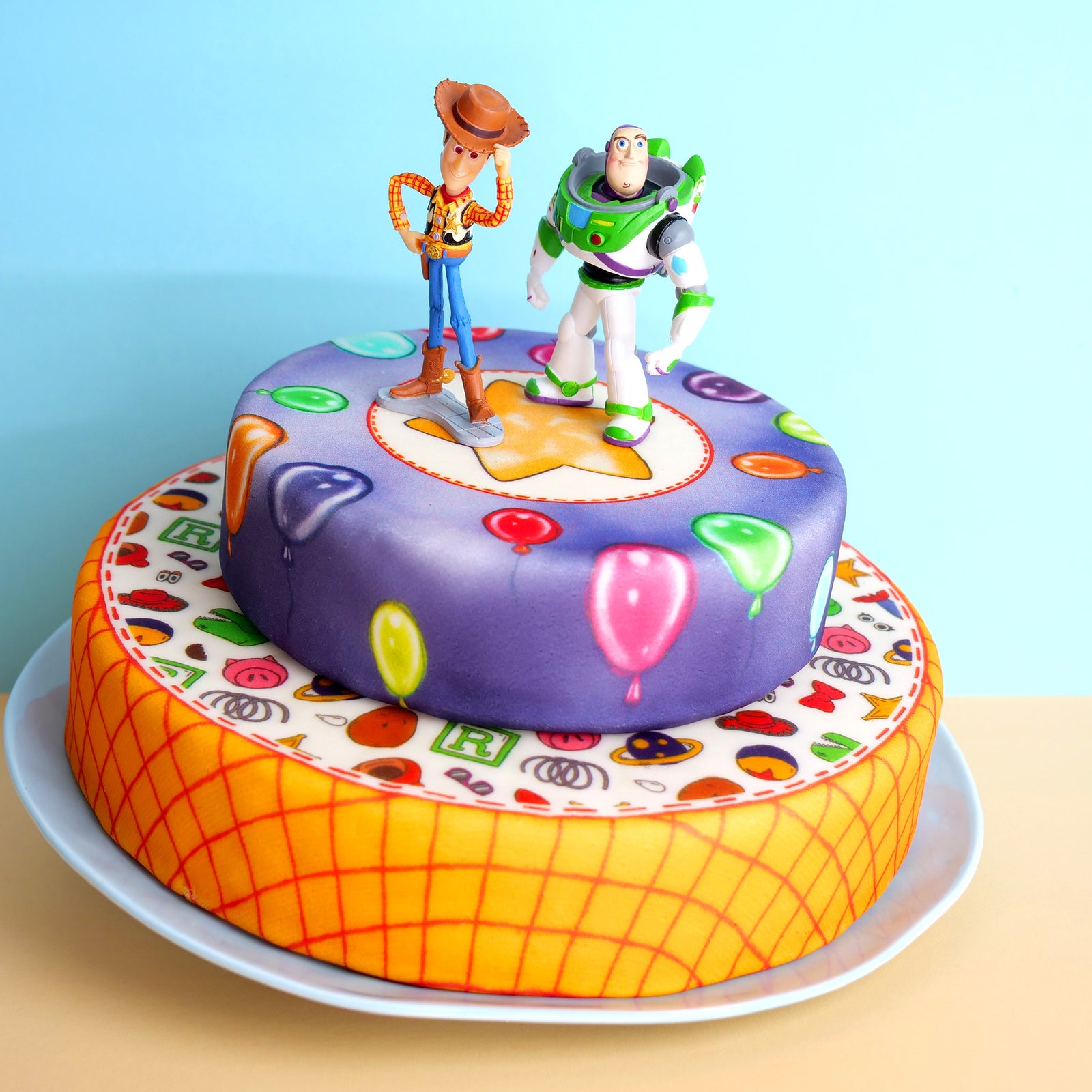 Cowboy Woody® & Buzz Lightyear® on a 2-tier toy-themed cake