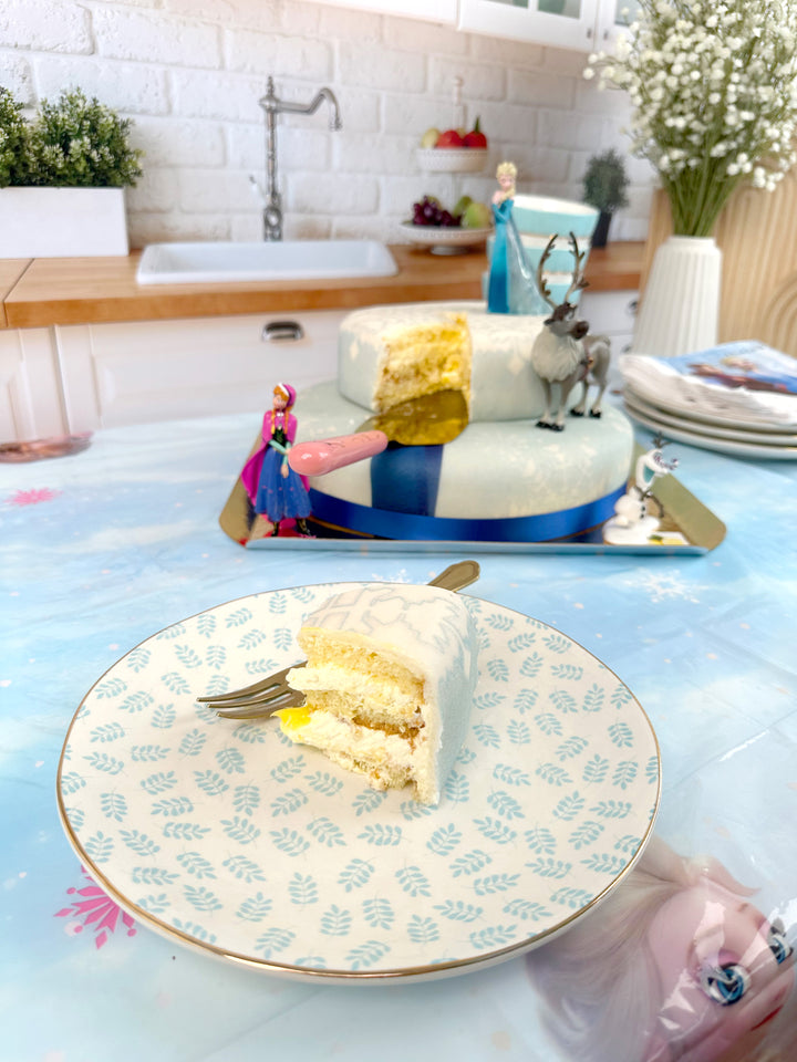 Frozen® Elsa, Anna & Olaf figures on a 2-tier snowflake cake