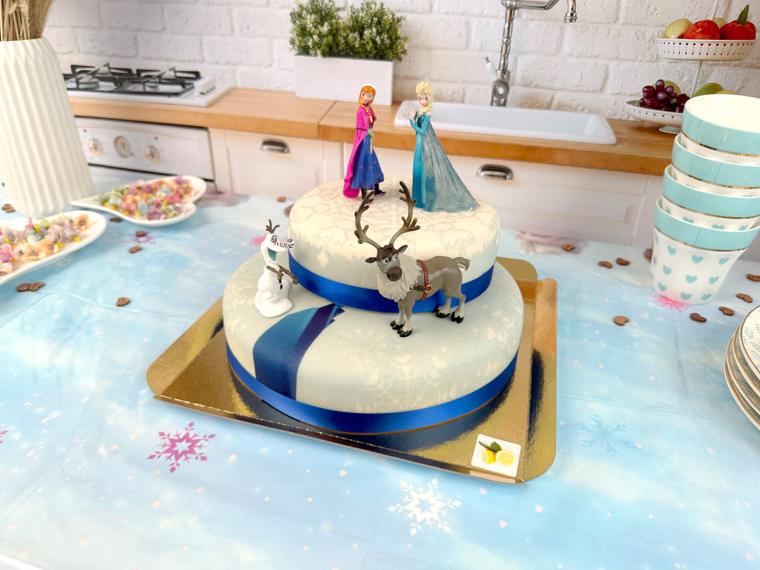 Frozen® Elsa, Anna & Olaf figures on a 2-tier snowflake cake