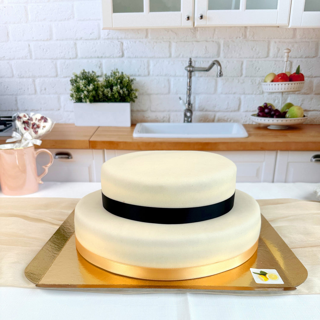 Two-tier white cake with cake ribbon