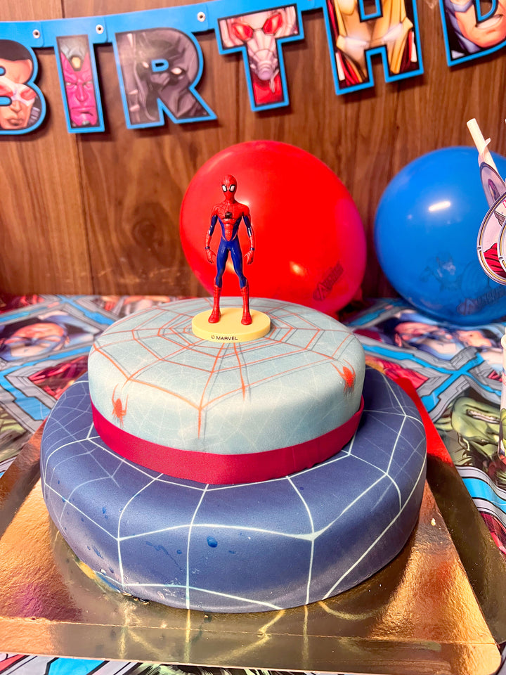 Spider-Man® on a two-tier spider’s web cake with ribbon