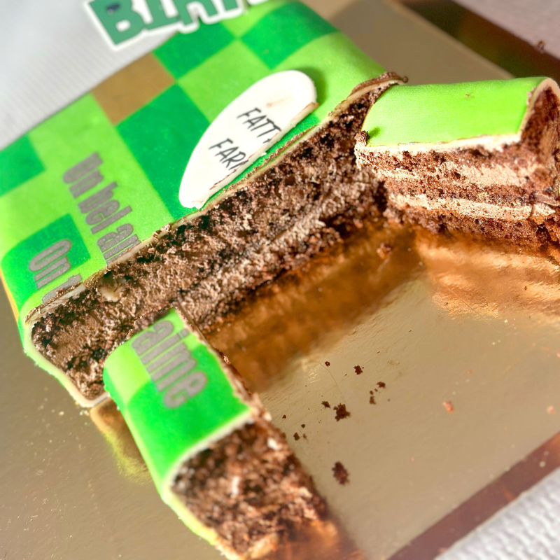 Minecraft® figure on game world cake