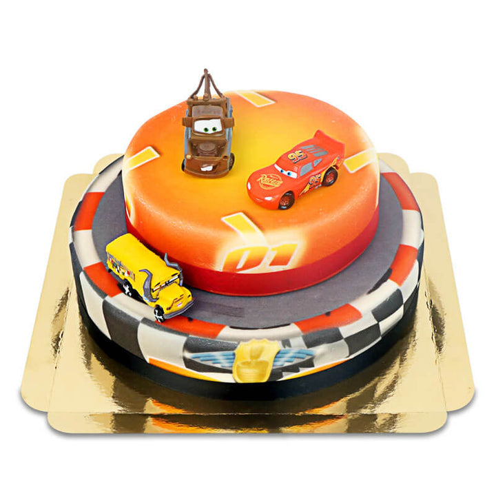 Cars® 2 – Lightning McQueen, Hook and Miss Fritter on a two-tier race track cake with ribbon