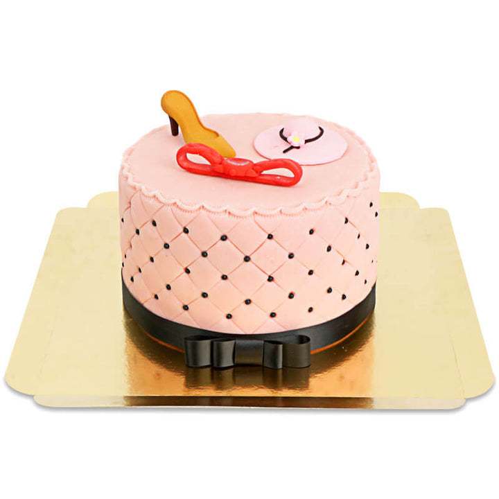 Deluxe make-up cake with colourful sugar decorations and a black ribbon