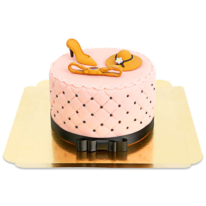 Deluxe make-up cake with colourful sugar decorations and a black ribbon