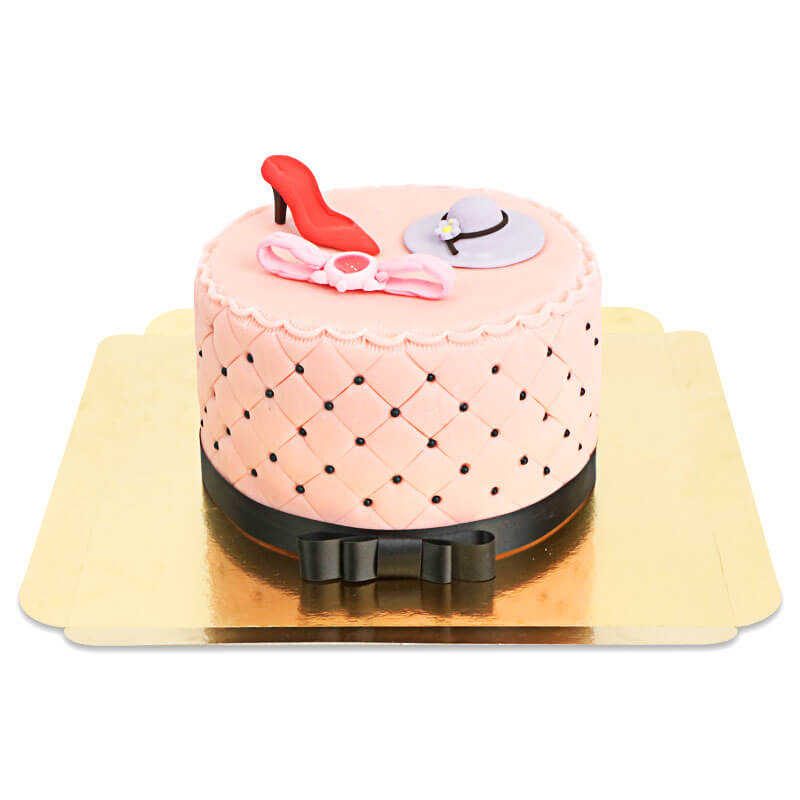 Deluxe make-up cake with colourful sugar decorations and a black ribbon