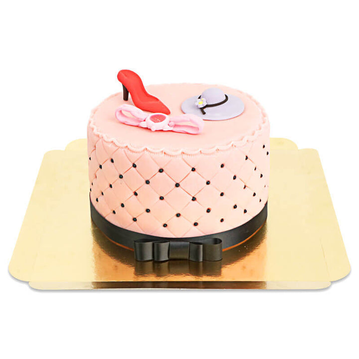 Deluxe make-up cake with colourful sugar decorations and a black ribbon