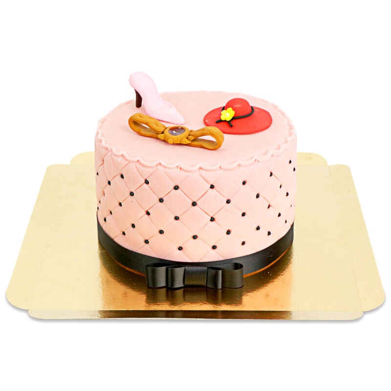 Deluxe make-up cake with colourful sugar decorations and a black ribbon