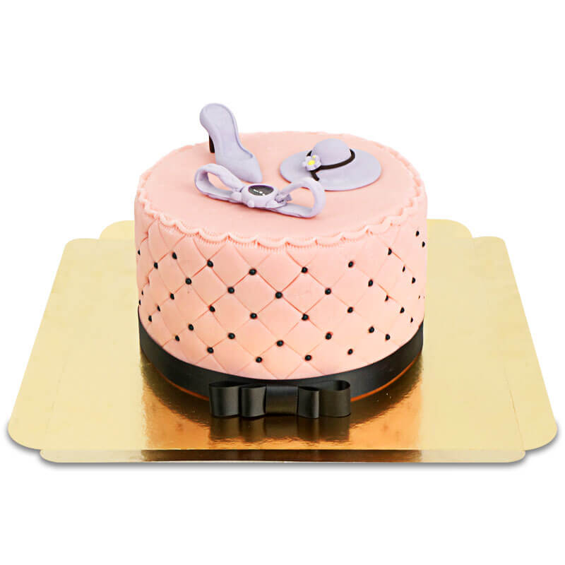Deluxe make-up cake with colourful sugar decorations and a black ribbon