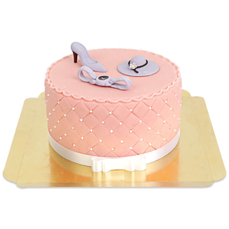 Deluxe make-up cake with colourful sugar decorations and a white ribbon