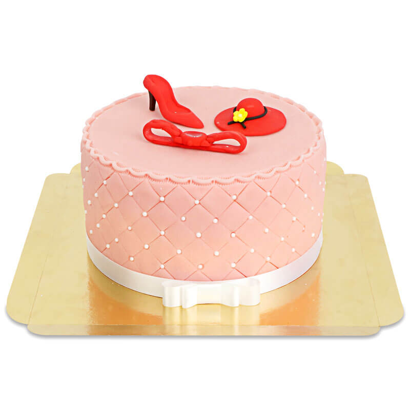 Deluxe make-up cake with colourful sugar decorations and a white ribbon