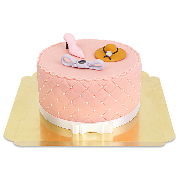 Deluxe make-up cake with colourful sugar decorations and a white ribbon