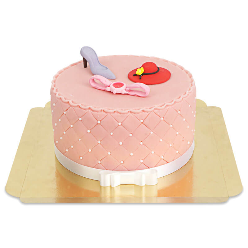 Deluxe make-up cake with colourful sugar decorations and a white ribbon