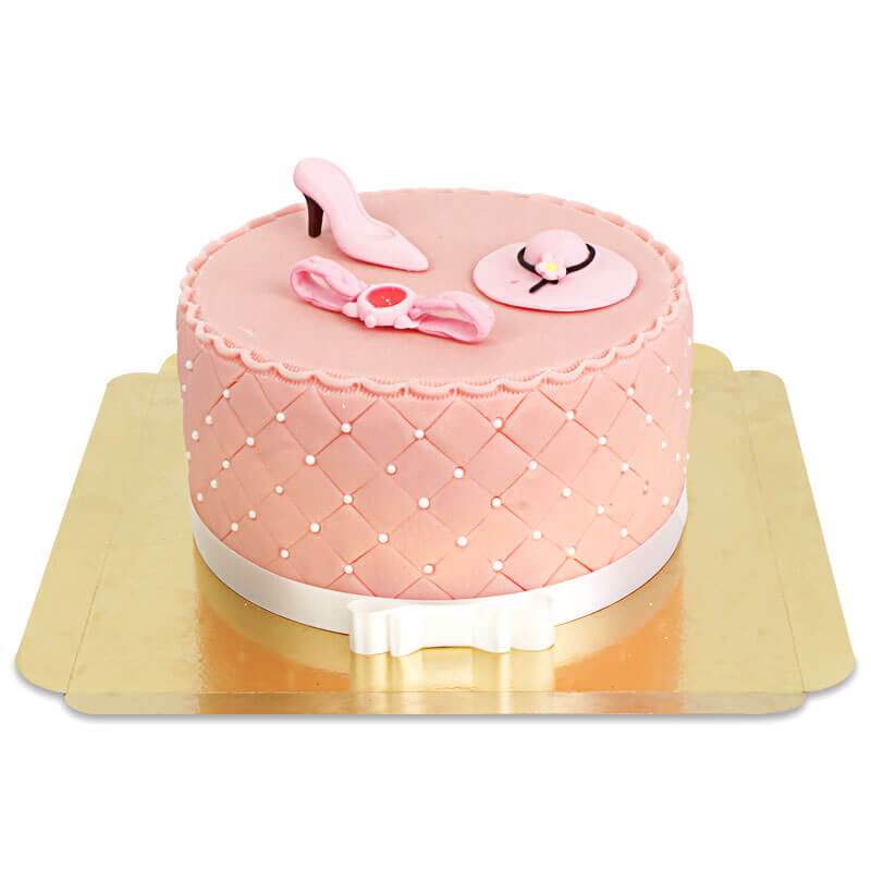 Deluxe make-up cake with colourful sugar decorations and a white ribbon
