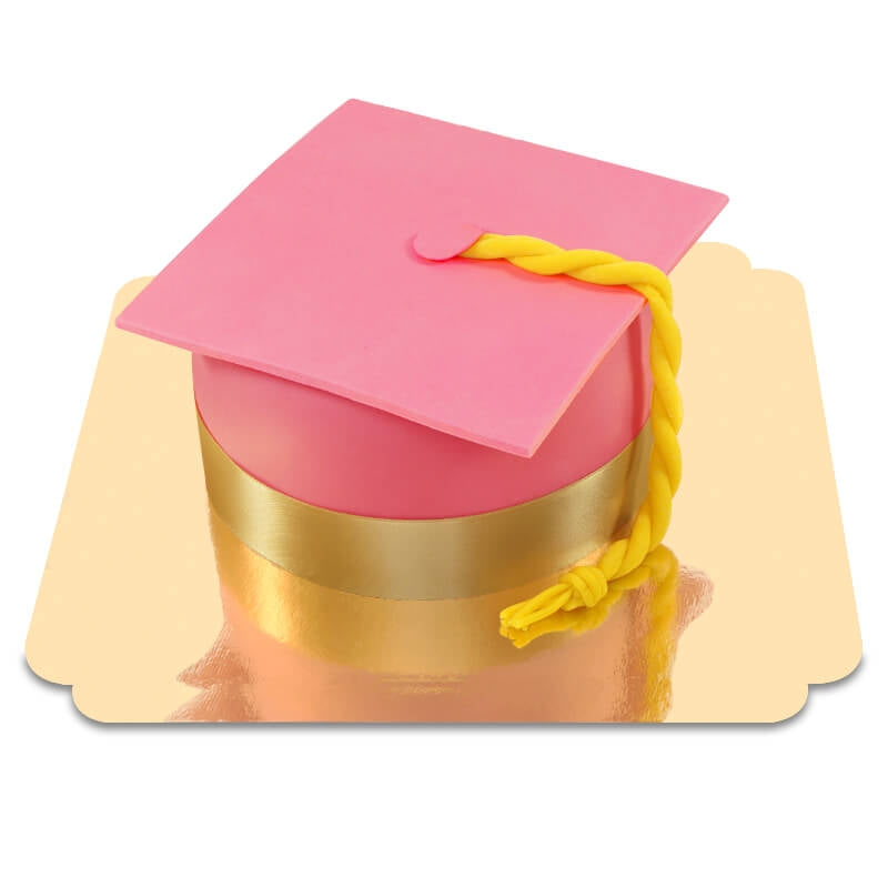 Graduation cake in the shape of a pink graduation cap
