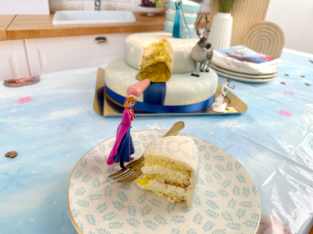 Frozen® Elsa, Anna & Olaf figures on a 2-tier snowflake cake