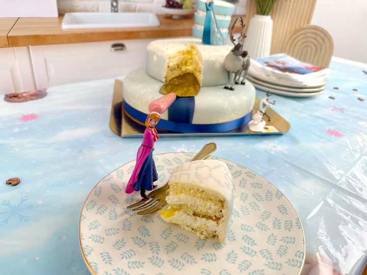 Frozen® Elsa, Anna & Olaf figures on a 2-tier snowflake cake