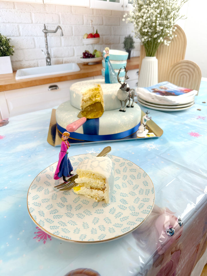 Frozen® Elsa, Anna & Olaf figures on a 2-tier snowflake cake