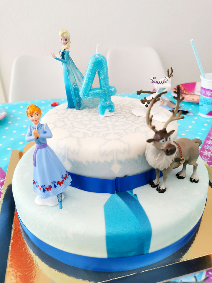Frozen® Elsa, Anna & Olaf figures on a 2-tier snowflake cake