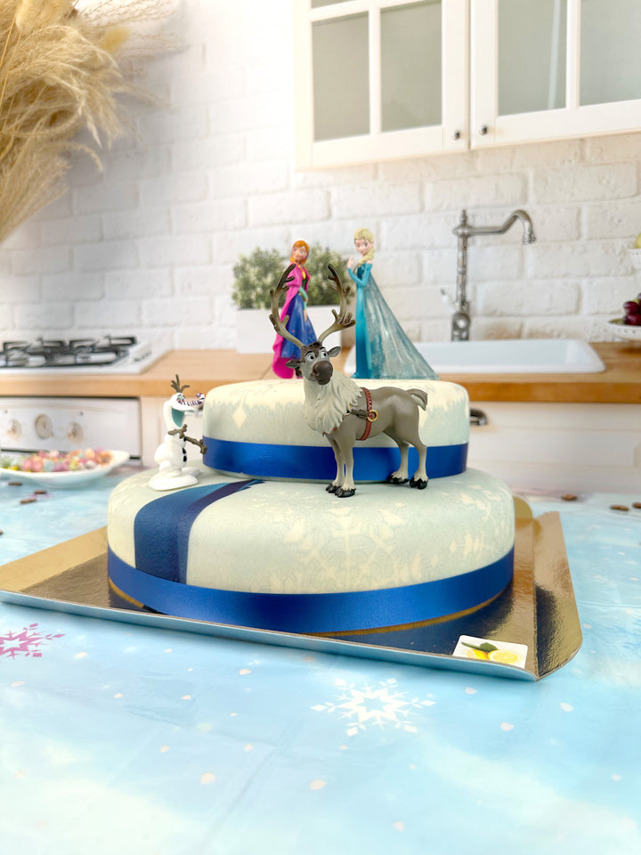 Frozen® Elsa, Anna & Olaf figures on a 2-tier snowflake cake
