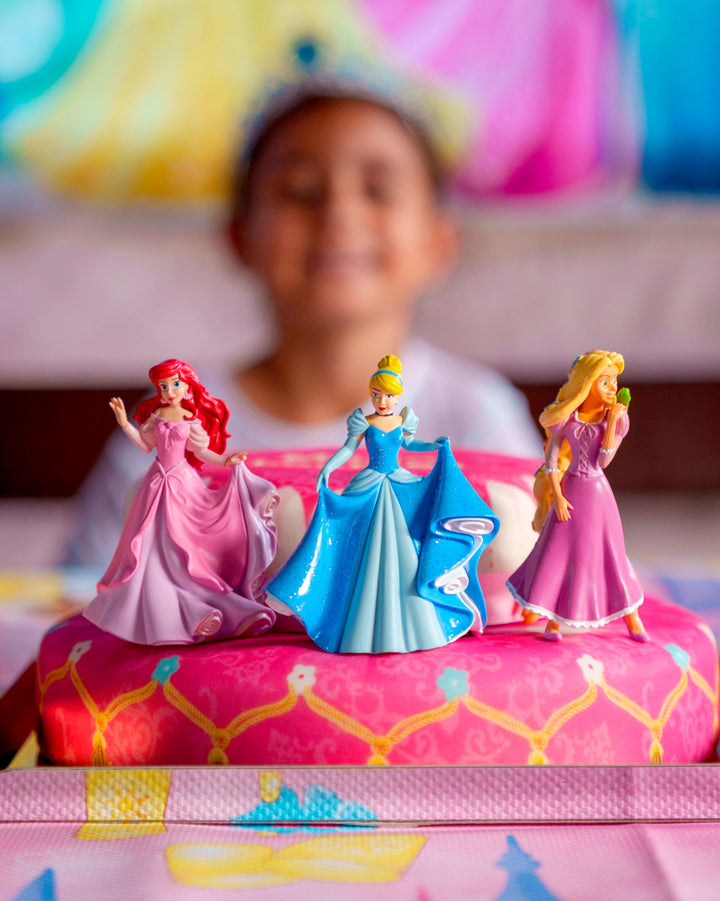 3 Princesses on a two-tier cake with a ribbon