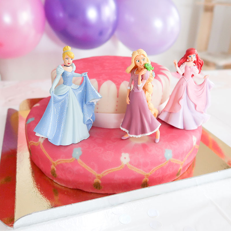 3 Princesses on a two-tier cake with a ribbon